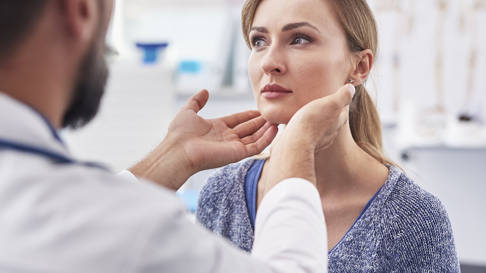 woman having her thyroid checked by a functional medicine doctor